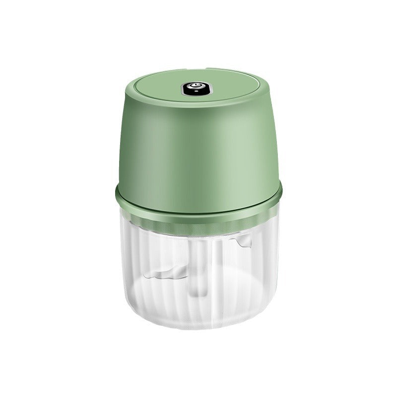 Green handheld food chopper on a white background