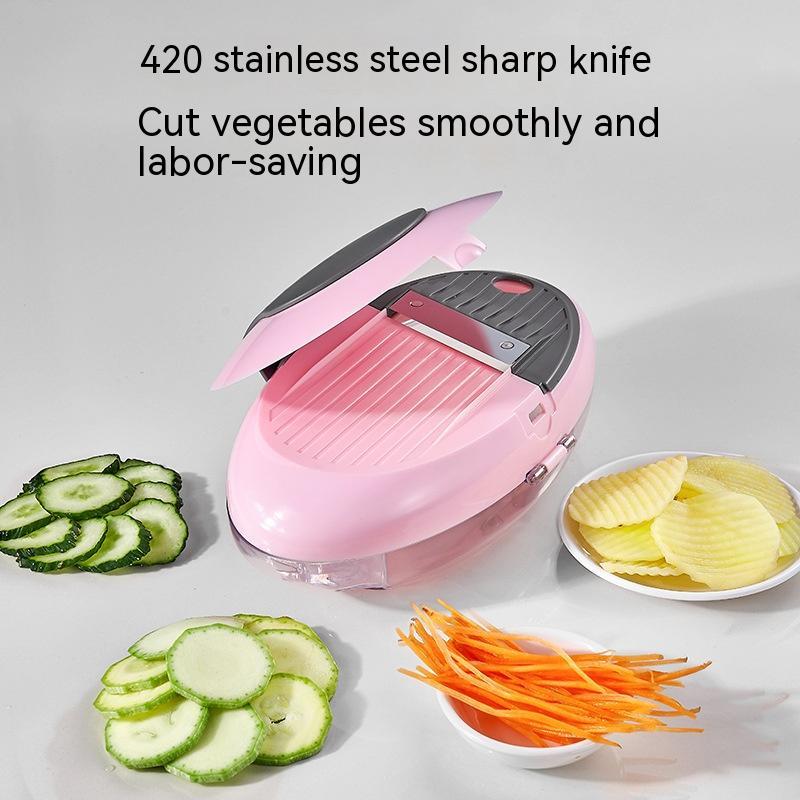 Pink vegetable slicer with sliced vegetables on a white background