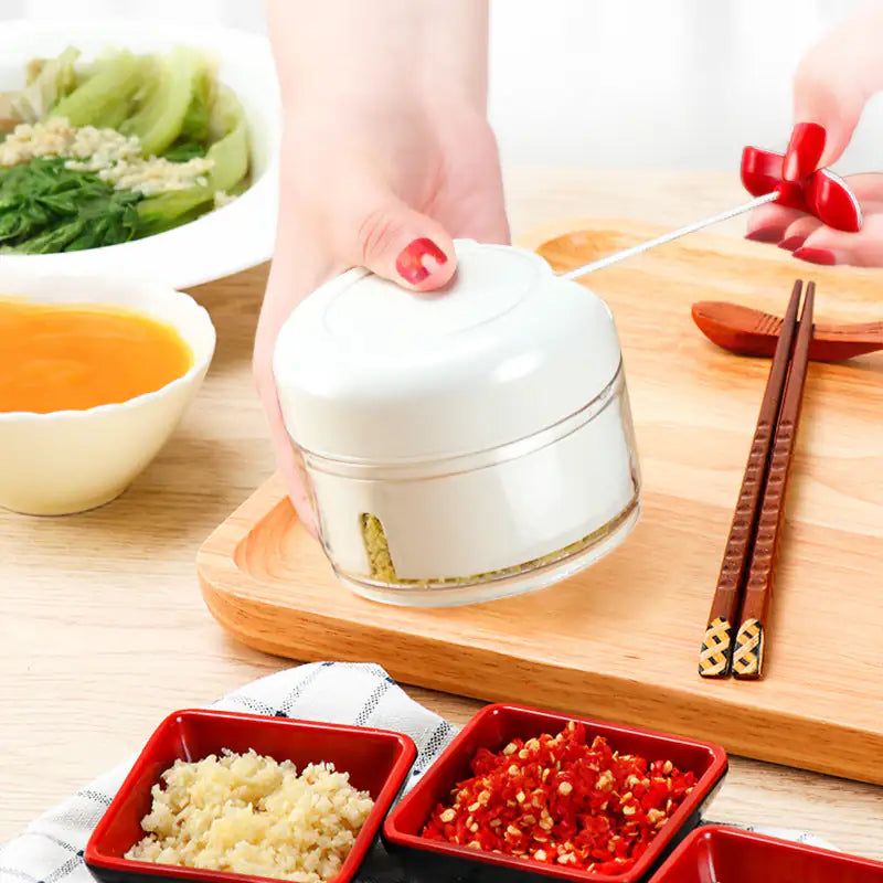 White container with a lid on a wooden cutting board with bowls of food and chopsticks.