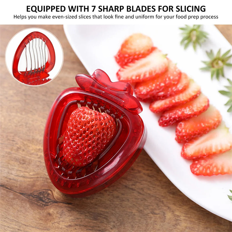 Red strawberry slicer with sliced strawberries on a white plate, placed on a wooden surface.