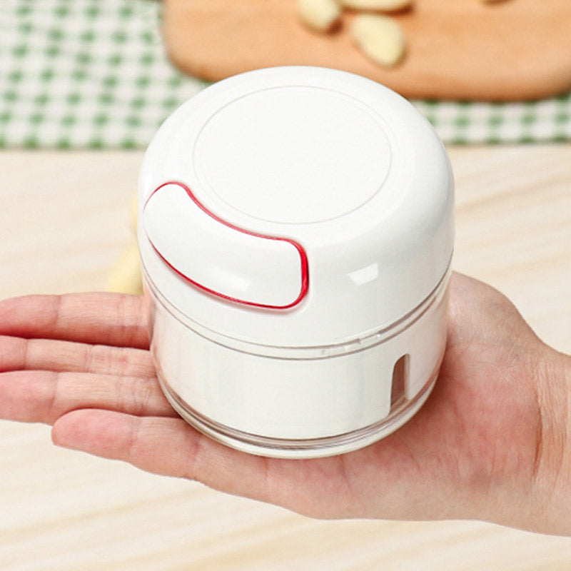 Small white container with a red accent held in a hand on a checkered tablecloth background