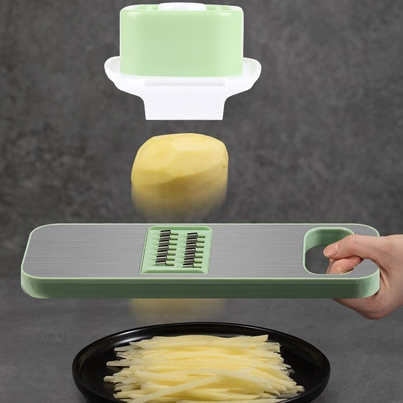 Vegetable slicer being used to slice a potato, with slices on a plate below.