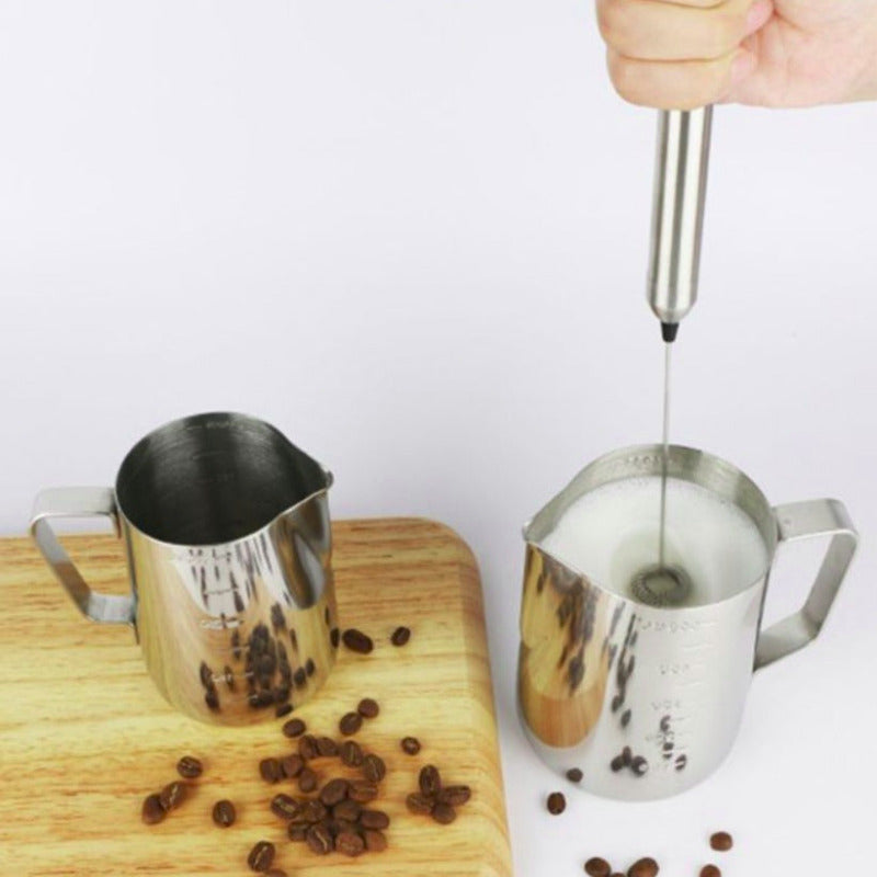 Person using a milk frother.