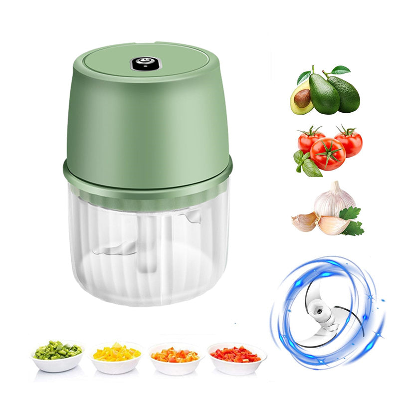 Green handheld food chopper with images of vegetables and a fan on a white background