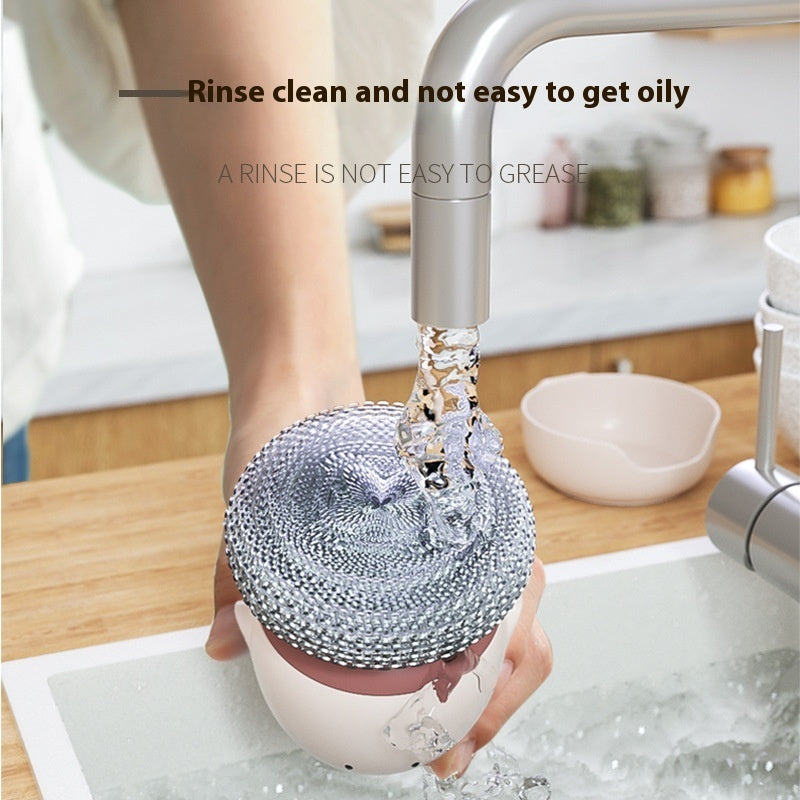 Person rinsing a dish with a silicone scrubber under running water in a kitchen.