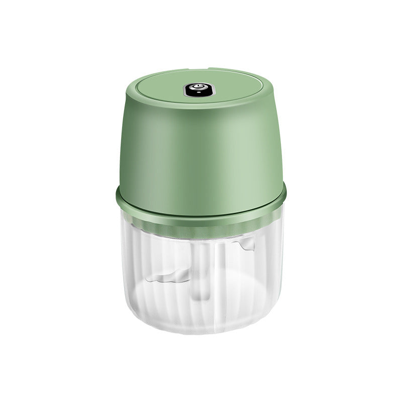 Green handheld food chopper on a white background