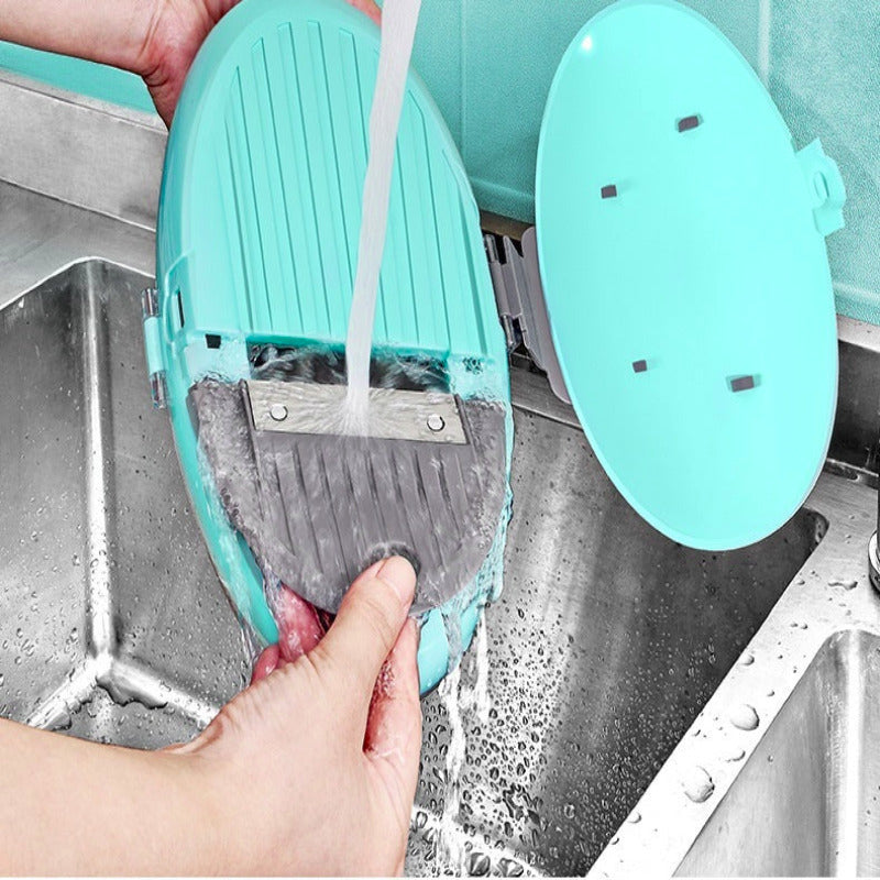Turquoise kitchen scrubber being used to clean a sink with water flowing over it.