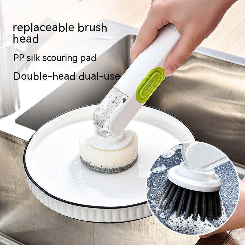 Cleaning brush with replaceable brush head and PP silk scouring pad being used on a dish in a sink.