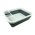 Collapsible dish drying rack with compartments on a white background