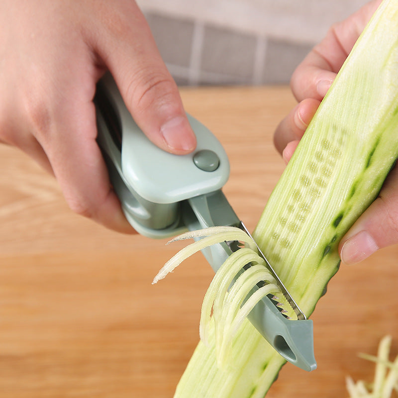 Person using a vegetable peeler to slice a cucumber on a wooden cutting board.