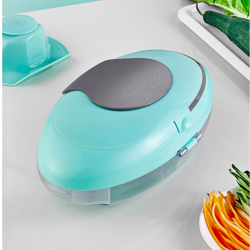 Turquoise vegetable peeler on a kitchen counter with vegetables in the background