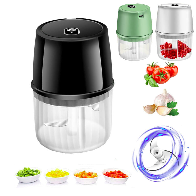 Black food chopper with additional attachments and chopped vegetables on a white background