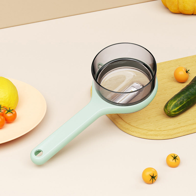 Light blue kitchen strainer on a white surface with vegetables around