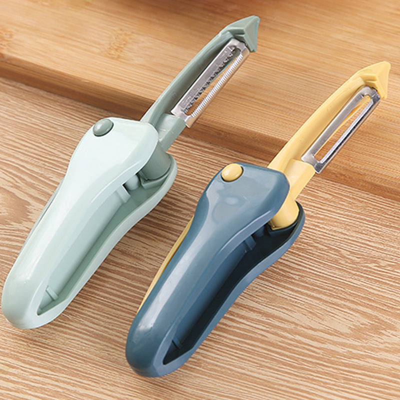 Two vegetable peelers on a wooden surface