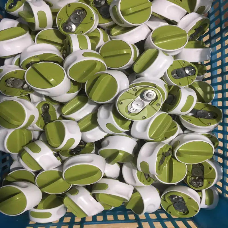 Pile of green and white cylindrical objects in a blue basket