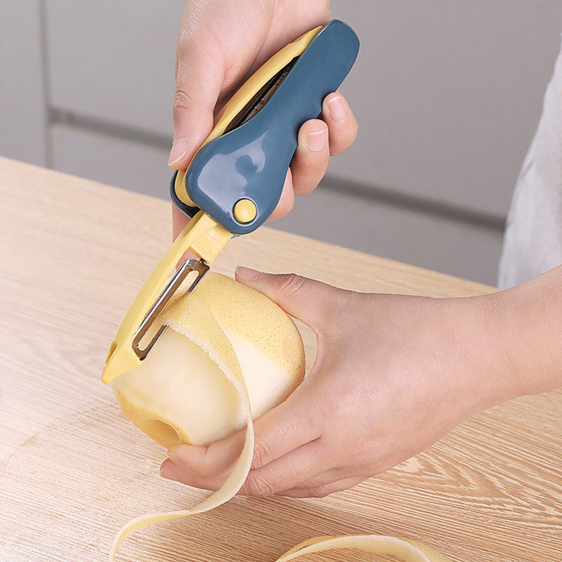 Person using a yellow peeler to peel a potato on a wooden surface.